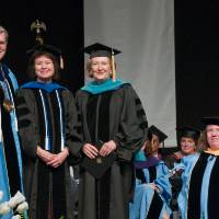 Helen DeVos standing with President Emeritus Tom Haas and provosts.